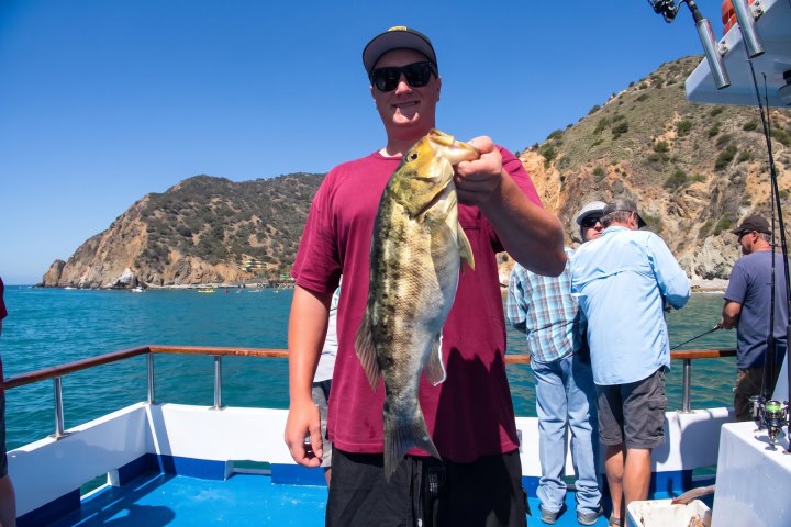 Angler with their catch on a Dana Wharf overnight fishing trip out of Dana Point