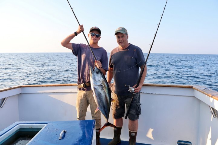 Angler with their catch on a Dana Wharf overnight fishing trip out of Dana Point