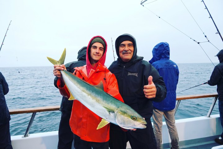 Angler with their catch on a Dana Wharf overnight fishing trip out of Dana Point