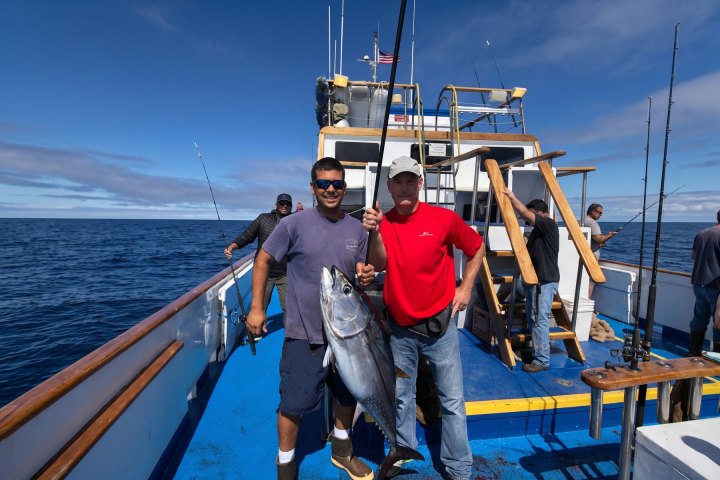 Angler with their catch on a Dana Wharf overnight fishing trip out of Dana Point
