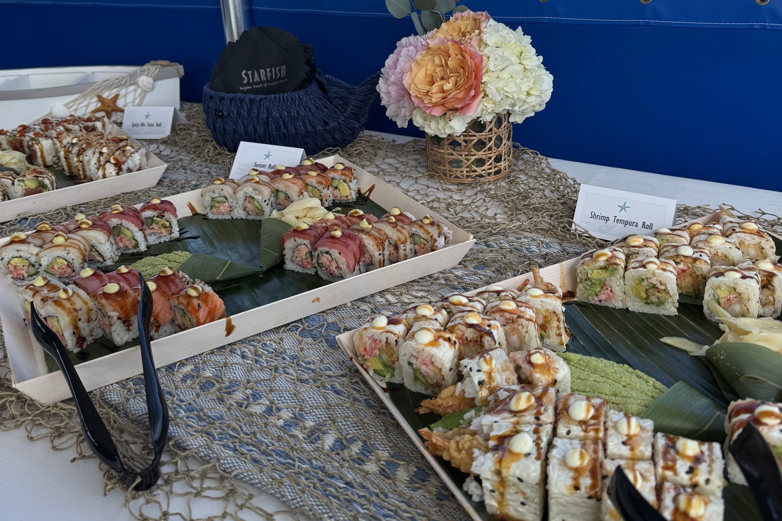 Flowers and sushi on the event table aboard a Dana Wharf catamaran