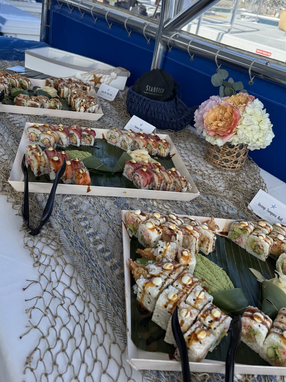 Sushi platters and flowers set out for a private event on board